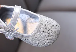 Detailed macro shot of a silver sparkly girl's princess Mary Jane shoe with rhinestones
