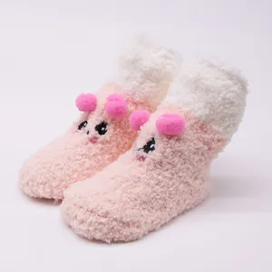 Soft plush pink and white cartoon baby socks with pom-poms and cute animal face detail