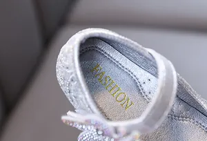 Close-up of sparkling silver glitter girls' princess shoe with FASHION insole detail