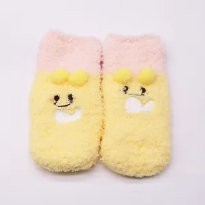 Detail showing soft plush texture of cute cartoon yellow baby floor socks