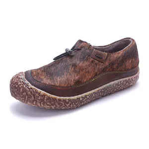 Close-up of retro handmade leather shoes with horsehair texture and colorful stitching