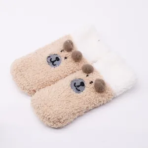 Detailed macro view of soft plush baby floor socks with a cute cartoon bear design