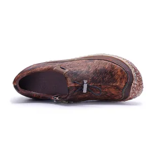 Detailed macro view of handmade leather shoes featuring vintage horsehair patchwork texture