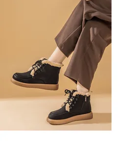 Detailed side profile of black fleece-lined flat snow boots with side zip closure