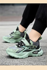 Detail shot of green and grey kids' chunky sneakers with non-slip soft rubber soles.