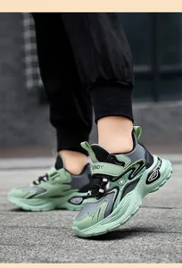 Close-up of children's green and grey non-slip sports sneakers with TRENDY strap.