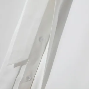 Close-up of white mesh panel stitching and button detail on men's banquet shirt
