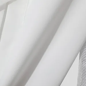 Close-up detail of a white men's shirt showing smooth fabric and mesh patchwork texture.