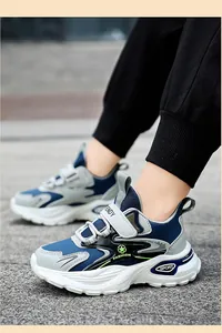 Close-up of children's blue and grey anti-slip sports sneakers with convenient velcro strap