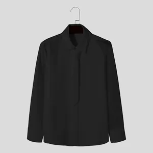 Detailed view of black long-sleeved shirt with mesh sleeve stitching and matching tie