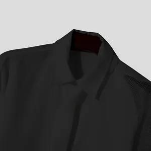 Close-up of black men's dress shirt with mesh sleeve detail and formal tie