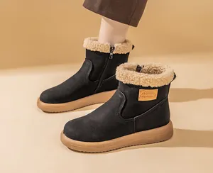 Detail view of black snow boots with warm faux shearling lining and side zipper.