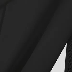 Detailed macro view of black mesh patchwork sleeve texture on a French style men shirt