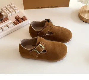 Detailed close-up view of brown suede children's Mary Jane shoes with vintage metal buckle