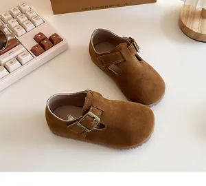Close-up view of brown suede British style toddler walking shoes with adjustable buckle