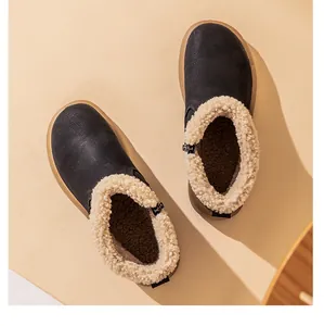 Macro view of warm black snow boots with plush beige faux shearling lining and soft gum soles.