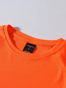 Close-up detail of a bright orange breathable mesh athletic shirt collar with brand label