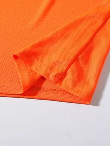 Detailed macro view of vibrant orange mesh fabric showcasing precision hem stitching.