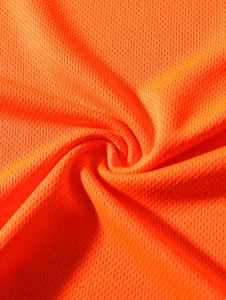 Macro detail of breathable orange honeycomb mesh fabric for men's sportswear