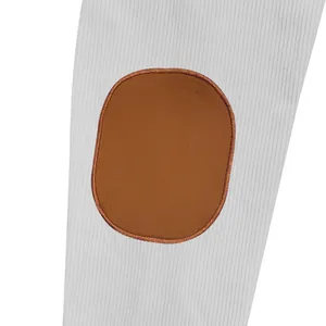 Macro detail of the premium brown faux leather elbow patch on a gray ribbed fleece jacket