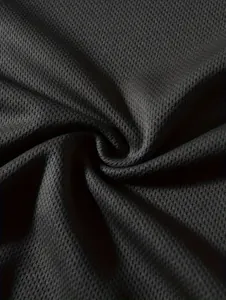 Detailed macro view of breathable black mesh fabric texture for men's long sleeve top