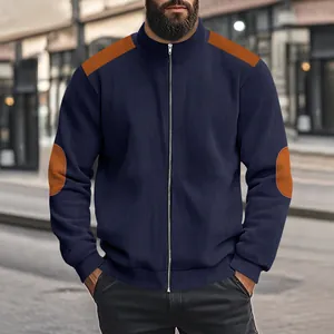 Detailed view of men's navy blue ribbed jacket with orange shoulder and elbow patches.