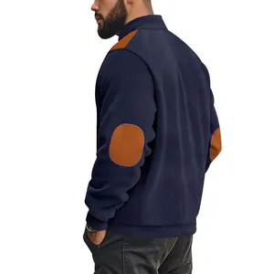 Detailed view of a navy blue corduroy jacket for men featuring brown suede elbow patches
