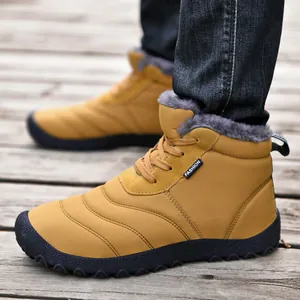 Detail of yellow outdoor winter boots with grey faux fur lining and non-slip sole