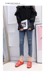 Model wearing red mid-heel wedge sandals with casual denim jeans for summer outfit