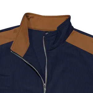 Macro detail of the stand collar and silver metal zipper on a navy blue fleece jacket.