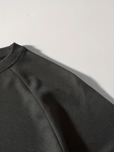 Macro detail view of the breathable black mesh fabric on a men's casual long-sleeve shirt.