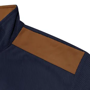 Close-up detail of navy blue ribbed velvet jacket with brown suede shoulder patch