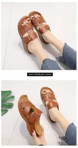 Close-up of brown platform sandals for women featuring stylish perforated leather straps