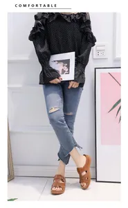 Brown wedge sandals worn with jeans and polka dot blouse in a casual setting