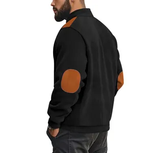Detail view of men's black ribbed cotton velvet jacket with brown elbow patches