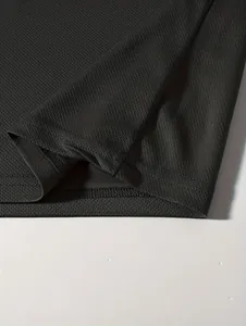 Detailed close-up showing the breathable mesh fabric and neat stitching of the black shirt