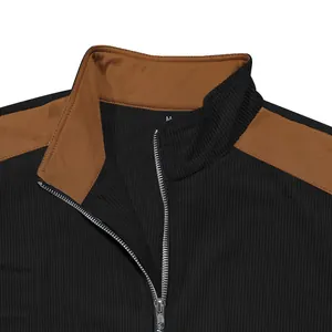 Detail view of stand collar and zipper on black and brown color block jacket