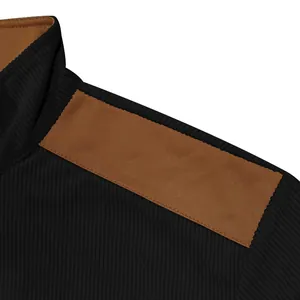 Close-up of the brown suede shoulder patch on a black ribbed zip-up fleece jacket detail.