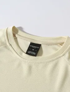 Detail view of men's cream mesh long sleeve t-shirt showing neckline and interior label