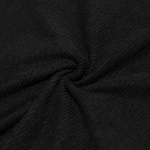 Macro view showing the detailed texture and ribbed pattern of black corduroy fabric