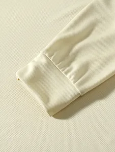 Close-up of the breathable mesh fabric and cuff detail on a men's long sleeve shirt.