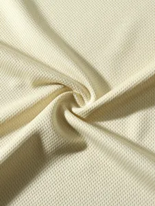 Close-up of breathable beige mesh fabric texture for men's base layer shirt