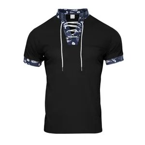 Close-up of black corduroy Henry shirt with blue paisley trim and lace-up collar detail.
