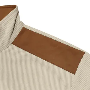 Detailed macro shot of a heavy corduroy jacket showing the stand collar and brown shoulder patch