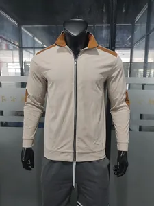 Front view of beige ribbed stand collar jacket with brown shoulder patches on mannequin