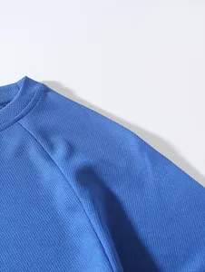 Close-up detail of breathable blue mesh fabric and reinforced neckline stitching