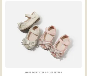 Detailed overhead view of elegant girl's princess shoes with pearl and rhinestone bows