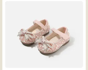 Close-up of pink toddler princess shoes with pearls and glittery bow detail