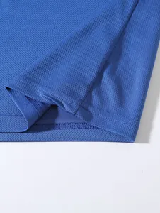 Macro detail of blue mesh fabric showing breathable texture and neat hem stitching.