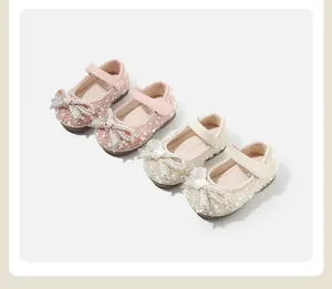 Close-up of pearl and rhinestone bows on elegant baby girl princess shoes